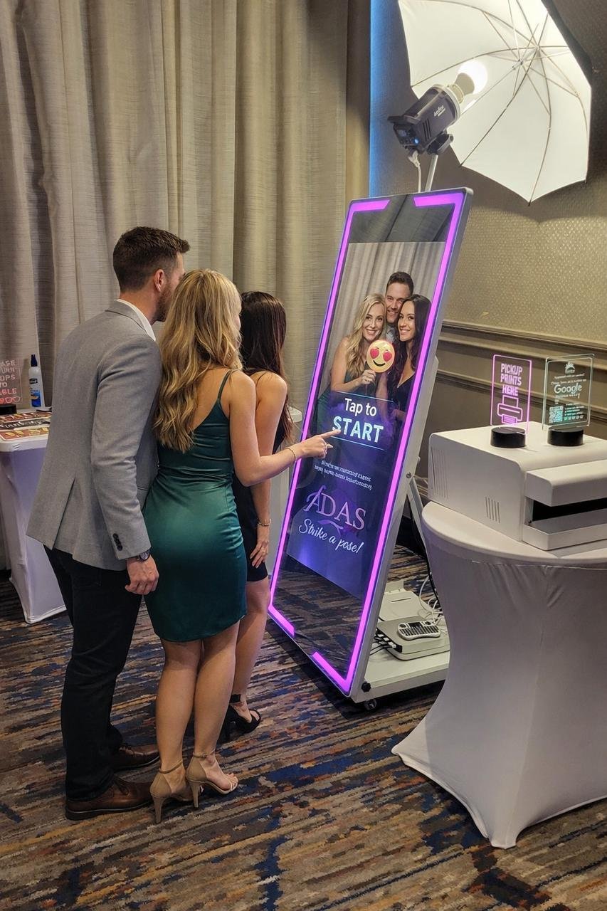 Wedding guest interacting with a mirror photo booth