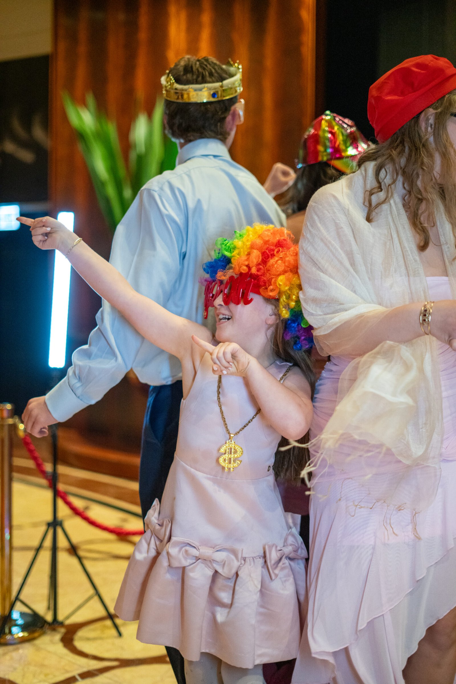 Two friends posing at a 360 photo booth setup